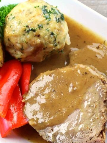 Sauerbraten with gravy, bread dumplings and vegetables.