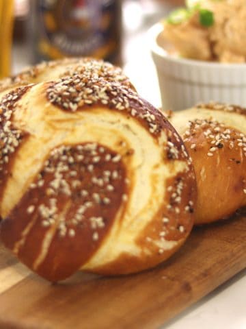 Everything pretzel knots with obazda and German beer in the background.