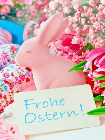 Easter bunny in flowers with "Frohe Ostern" sign announcing German Easter food.