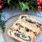 A plate with slices of German poppy seed roll with streusel topping